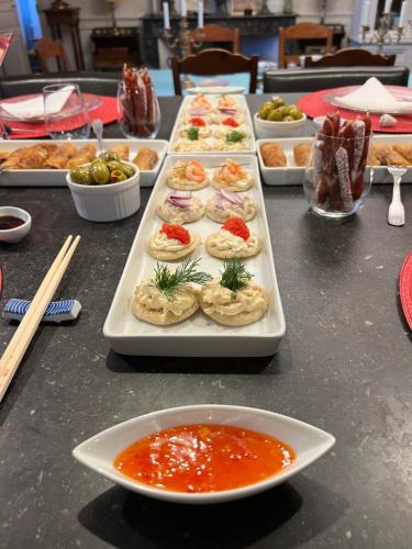 een tafel met verschillende dienbladen eten en een bord soep bij Le Loriot in Champagne-et-Fontaine