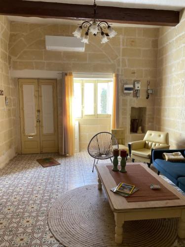 a living room with a couch and a coffee table at Villa Vella - 2 Bedroom House Gozo in Taʼ Abram