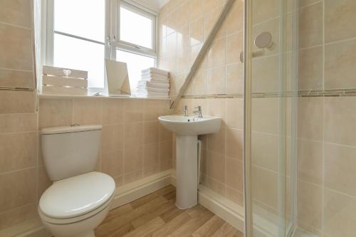 uma casa de banho com um WC e um lavatório em Pebblesden em Hunstanton