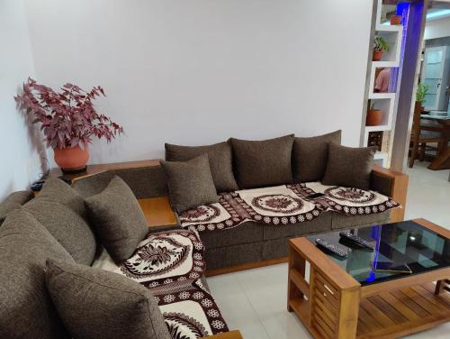 a living room with a couch and a coffee table at Olive Celestina in Kottayam