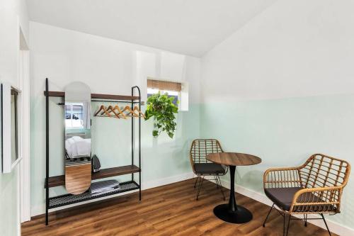 a room with a table and two chairs and a table at Wānanapaoa Studio suite.komo nui in Chandler