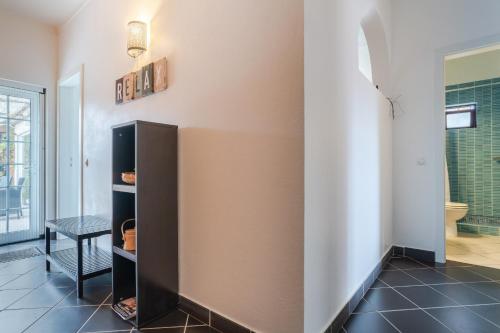 a room with a wall with a shelf at Rustic Retreat in Algoz in Algoz