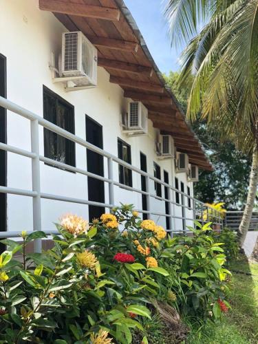 a white building with flowers in front of it at La Manola Finca Hotel in Doradal