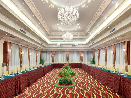 a banquet hall with a christmas tree in the middle at The Grand Bali Nusa Dua in Nusa Dua