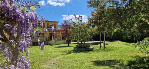 a house with purple flowers in the yard at 4 Bedroom Villa with Private Pool within 5 minute walk into Quillan in Quillan