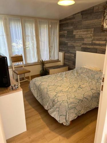 a bedroom with a bed and a tv in it at T3 saisonnier - Frouge 46400 Autoire - Lot in Autoire