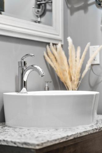 a white sink on a counter in a bathroom at The Mountaineer by InstantSuites Pool & HotTub in Canmore