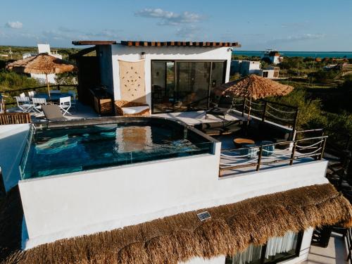 a villa with a swimming pool and the ocean at Luxury Villa Ocean View "Casa Mar" in Holbox Island