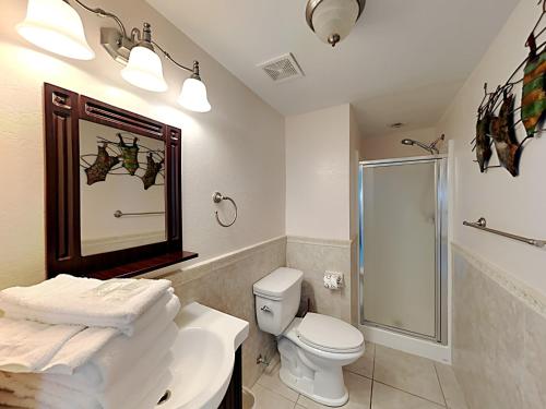 a bathroom with a shower and a toilet and a sink at Villas on the Gulf #N1 in Pensacola Beach
