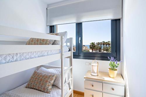 ein Schlafzimmer mit Etagenbetten und einem Fenster in der Unterkunft Apartamento El Castillo in Roquetas de Mar
