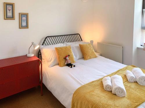 a teddy bear sitting on top of a bed at Mill Court in Dunblane
