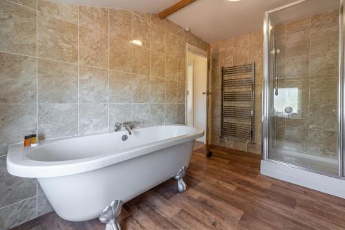 a large bathroom with a tub and a shower at 2 Providence Place in Thornage