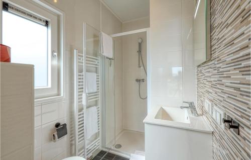 a white bathroom with a sink and a shower at Sonnenschein in Süsel