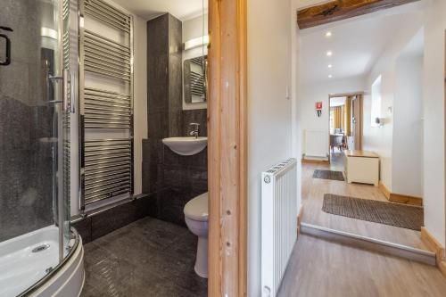 a bathroom with a toilet and a sink at Basil Cottage in Wells next the Sea