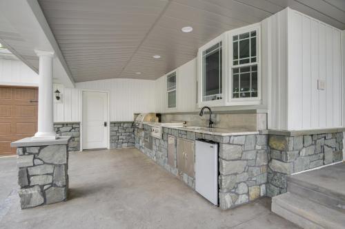a kitchen with a stone counter and a sink at Waterfront Home with Hot Tub in Wrightsville! in Wrightsville