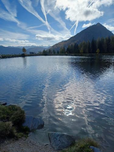 a large body of water with a mountain in the background at Ferienwohnung BergTime in Weißenbach bei Liezen