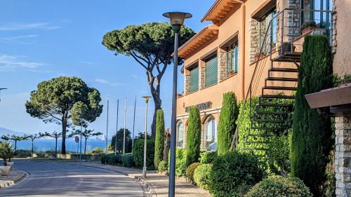 a building with a street light next to a road at Hotel Sa Punta - Adults Only fr13 in Begur