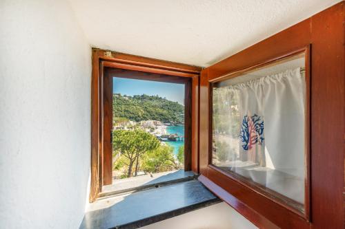 a window with a view of the ocean at Torre Turbolo Apartments in Massa Lubrense