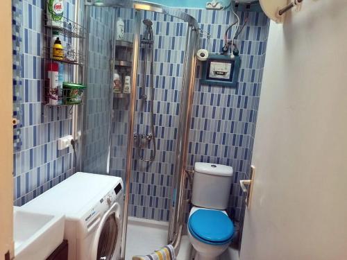 a bathroom with a shower with a toilet and a sink at Cozy studio in Costa del Silencio in the south coast of Tenerife in Costa Del Silencio