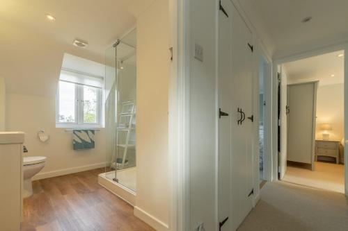 a bathroom with a shower and a toilet at Cherry Tree Cottage GB in Great Bircham