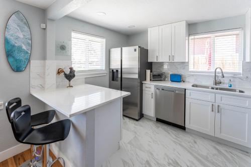 a kitchen with white cabinets and a counter top at Hidden Gem of Arvada! in Arvada