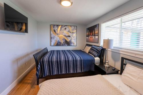 a small bedroom with a bed and a window at Hidden Gem of Arvada! in Arvada