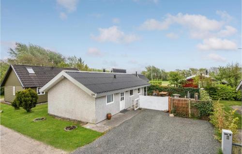 a house with a driveway in a yard at Holiday Home Hemmet 37 in Falen