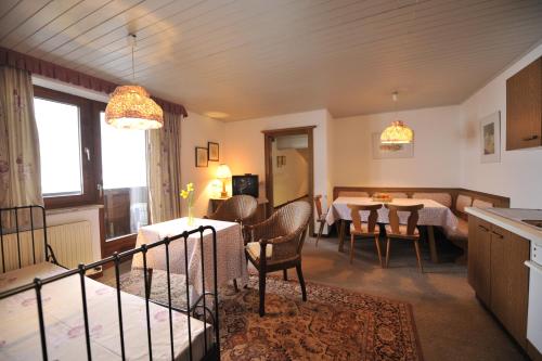 a kitchen and dining room with a table and chairs at Apparthotel Restaurant Steiners in Eben im Pongau