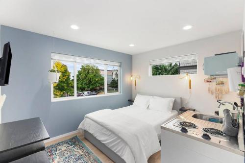 a small bedroom with a bed and a sink at Anders' sweet suite - Micro Studio - 91Walkscore in Seattle