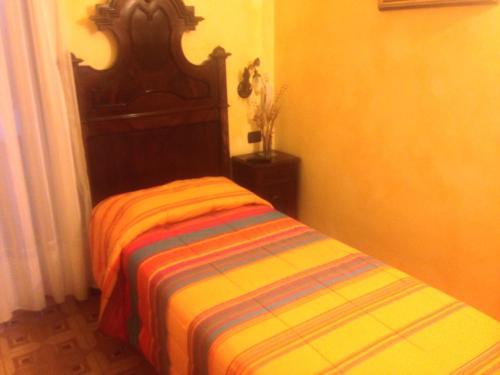 a bed in a room with a colorful blanket on it at Albergo Etrusco in Calusco dʼAdda