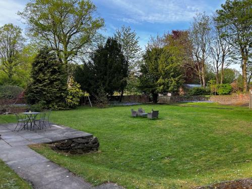 a park with a table and benches in the grass at No.2 Beechcroft / Park-Side / Ping Pong & Garden in Liverpool
