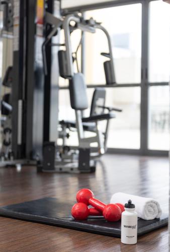 a black mat with red fruit on a gym floor at Monreale Plus Guarulhos International Airport in Guarulhos