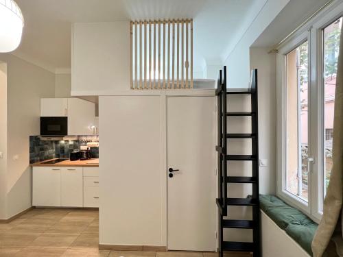 a room with a staircase leading up to a kitchen at Appartements neuf - Frontière de Monaco - clim - WIFI in Cap d'Ail
