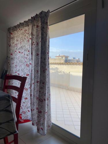 a sliding glass door with a view of a balcony at Mansarda mentana in Vittoria