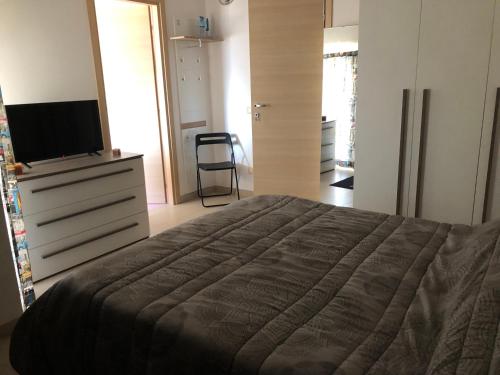a bedroom with a bed and a dresser with a television at Mansarda mentana in Vittoria