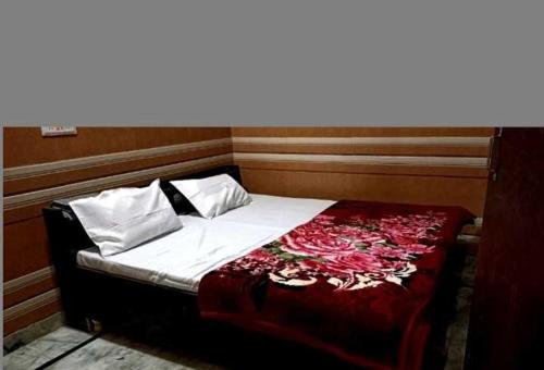a bed in a small room with at OYO Kk Hotel in Meerut