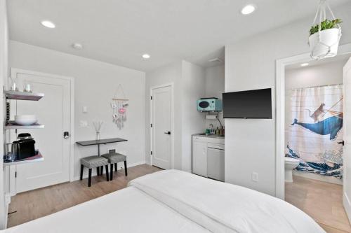 a white room with a bed and a kitchen at Evan's sweet suite - Micro Studio - 91Walkscore in Seattle