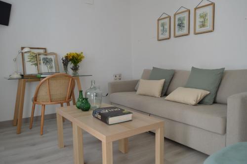 un salon avec un canapé et une table basse dans l'établissement ISG Apartments Precioso ático con terraza privada en el centro- FREE PARKING, à Séville