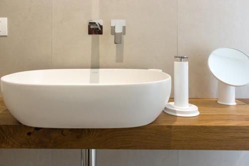 a bathroom with a white sink and a mirror at Zia Maria in Fasano