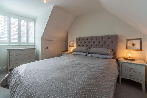 a bedroom with a large bed with a large headboard at Barn Cottage 6 in Salthouse