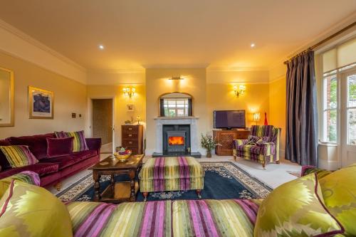 a living room with a couch and a fireplace at Ivy Farm in Grimston