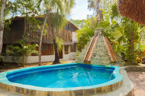 a swimming pool in front of a villa at OMA CANCUN - Holistic Healing Center in Cancún