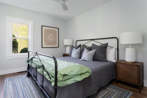a bedroom with a bed and a window at Idyllic Asheville Countryside Home on 70 Acres in Mars Hill