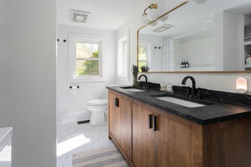 a bathroom with a sink and a mirror at Idyllic Asheville Countryside Home on 70 Acres in Mars Hill