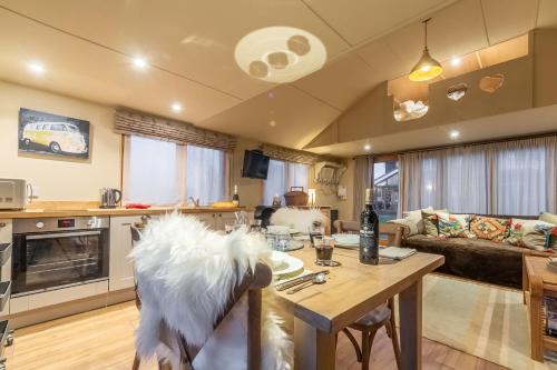 a living room with a dog sitting on a table at The Bothy in Ringstead