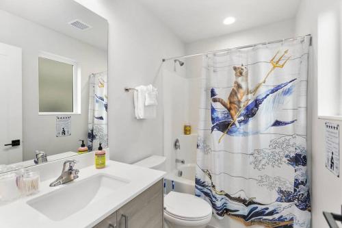 a bathroom with a toilet and a shower curtain at Chase's sweet suite - Micro Studio - 91Walkscore in Seattle