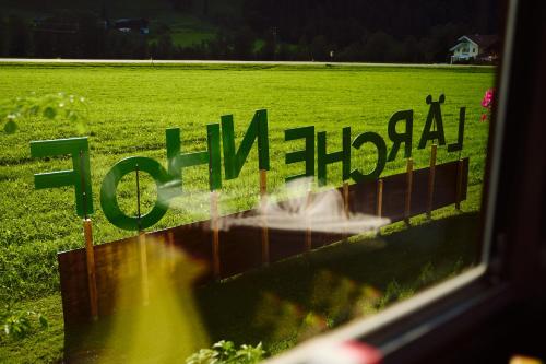 a sign in a window with a field in the background at Hotel LÄRCHENHOF in Kleinarl