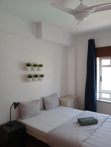 una camera da letto con un letto con piante sul muro di Cacilhas Mini Hostel a Cacilhas