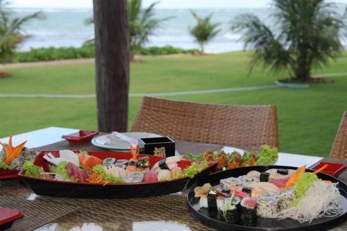 a table with a tray of food on it at Serrambi Resort in Porto De Galinhas