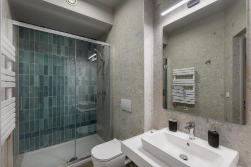a bathroom with a sink and a shower and a toilet at Florin Apart Hotel in Budapest